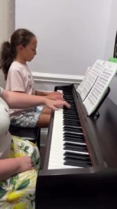 A young student at her piano lesson at Virtuoso School of Music and Art in Charlotte, NC